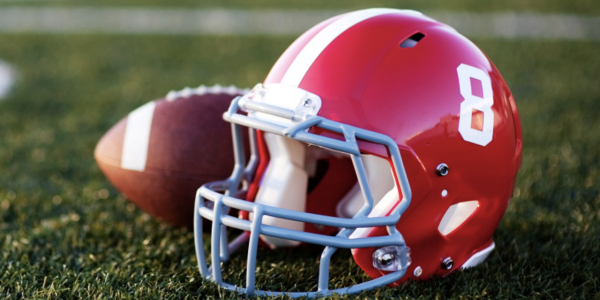 Football next to a red football helmet with the number 8 on the side